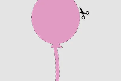 Rosa Luftballon wird mit Schere ausgeschnitten